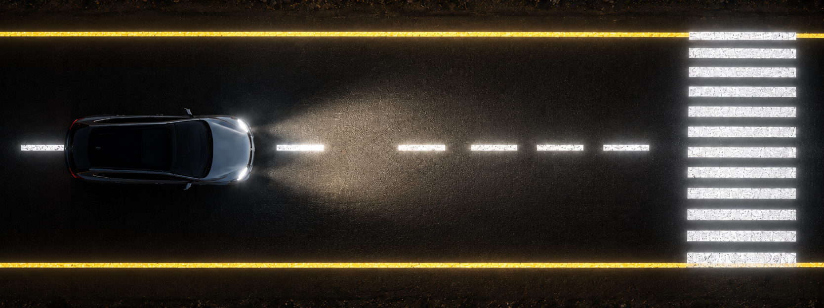 Reflective road markings and zebra crossing visible at night